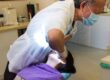 Dentist performing tooth extraction in dental clinic, representing dentists and tax concerns